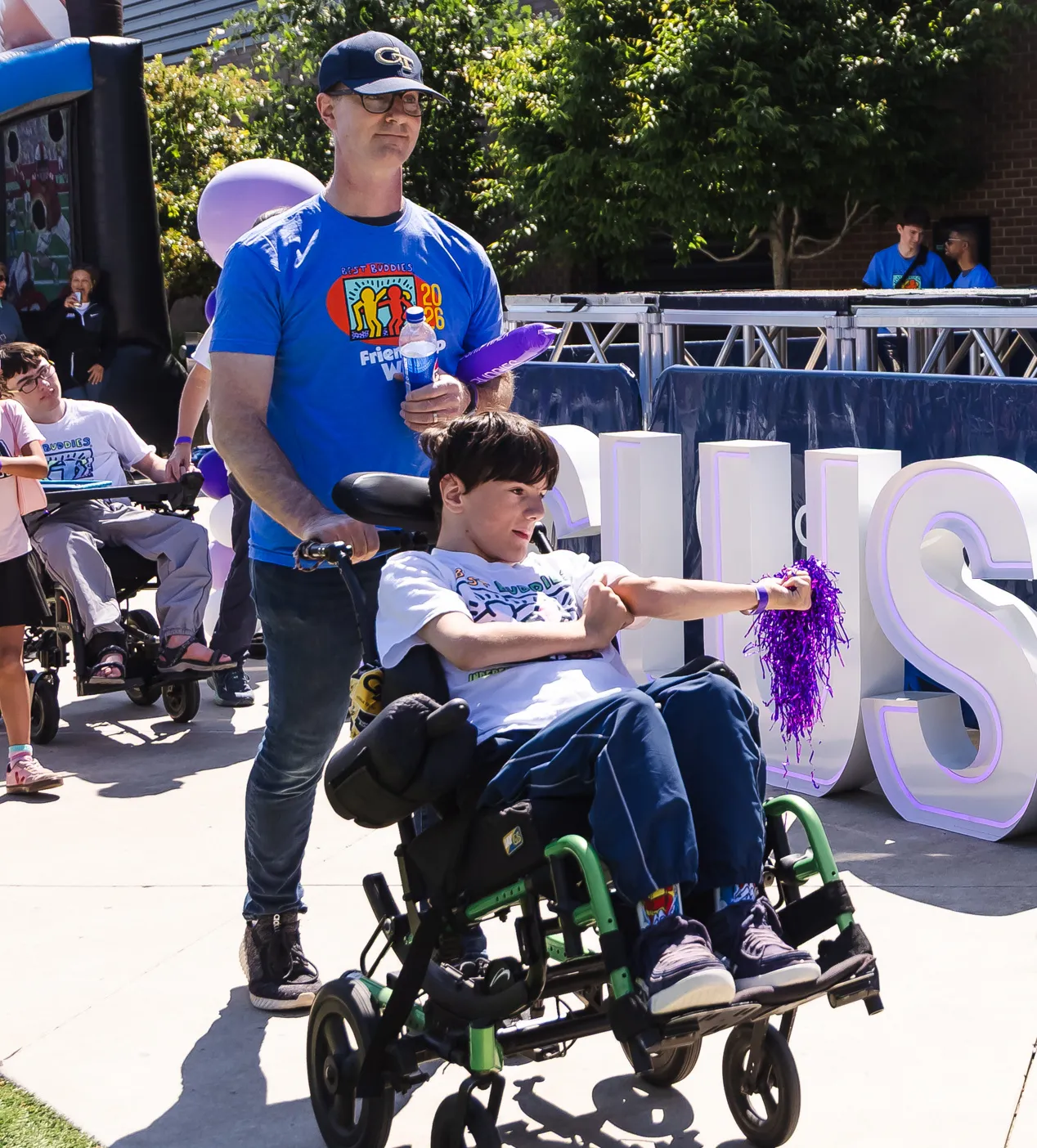 supporter with young man in a wheelchair